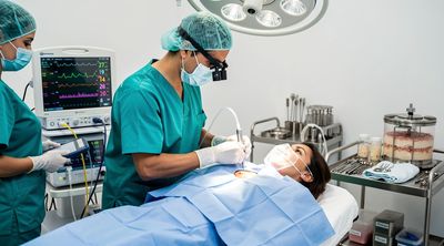 A surgeon performs a Brazilian Butt Lift procedure on a patient in a sterile Tijuana operating room.