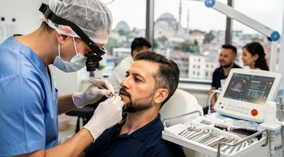 A Turkish surgeon performing a hair transplant in an Istanbul clinic with diverse patients.