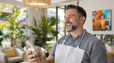 American patient smiling with new dental bonding work at Mexican clinic reception