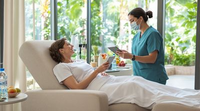 American woman relaxing in Mexican dental recovery lounge with nurse explaining post-op care