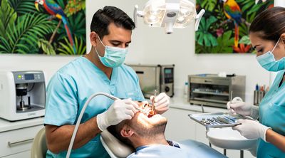 A dentist performing a dental implant procedure on a patient in a advanced Costa Rican clinic.