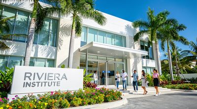 Modern exterior of a JCI-accredited clinic in Cancun welcoming diverse medical tourism patients.
