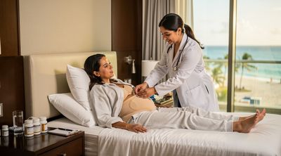 A doctor checking on a recovering patient in a comfortable Mexican hotel room.