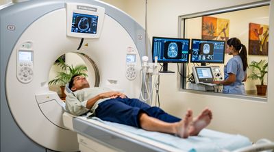 A diverse patient undergoing a knee MRI in a modern Mexican clinic.