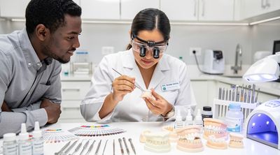 A dental technician applies composite veneers in an affordable Mexican laboratory setting.