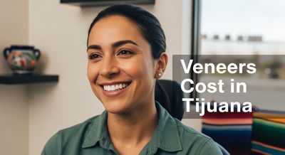 A happy American patient smiling with new veneers in a Tijuana dental clinic, highlighting affordable smile makeovers.